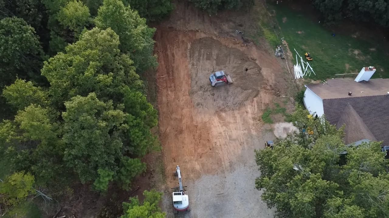 Excavation and complete site preparation in Central Arkansas Aerial view of a graded, build-ready site with a new access road in Central Arkansas