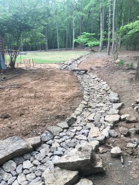 Dry creek drainage channel carrying stormwater away from a site